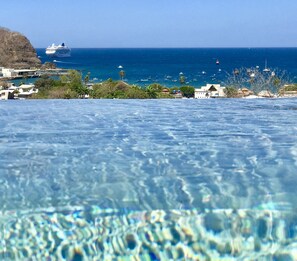 A clear view of a swimming pool with a view of the ocean and boats in the distance. - La Santa Maria Boutique Hotel & Residences San Juan del Sur Nicaragua (San Juan del Sur)