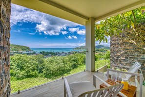 A balcony with a view of a coastal landscape, including a sea and greenery. - La Santa Maria Boutique Hotel & Residences San Juan del Sur Nicaragua (San Juan del Sur)