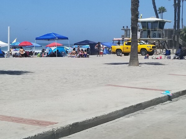 A beach with tents and a lifeguard tower. - 180°OceanViews, Private BeachHouse on Strand! LGDeck,F-pit,BBQ, AC, ... Sleeps8. (Oceanside)