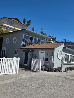 A two-story building with a balcony, a white gate, and a 'For Rent' sign. - 180°OceanViews, Private BeachHouse on Strand! LGDeck,F-pit,BBQ, AC, ... Sleeps8. (Oceanside)