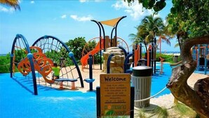 A playground with various play structures, a sign indicating it is for children under 5, and a beach theme. - BY THE SEA VACATION VILLAS 4 BED PRIVATE POOL/BEACH NEAR-LBTS gated community (Lauderdale by the Sea)