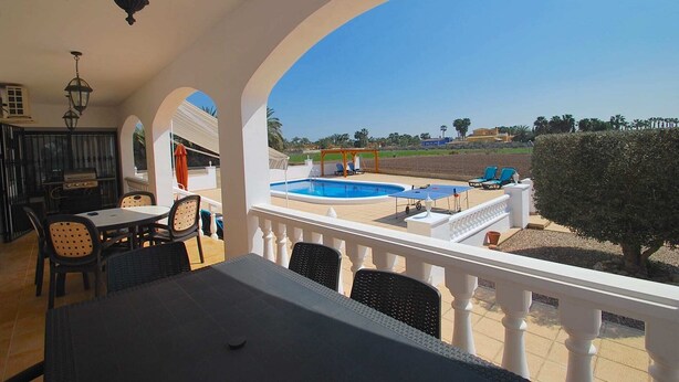 A terrace with a pool, outdoor seating, and a view of the landscape. - Finca in quiet area with private pool (Catral Alicante)