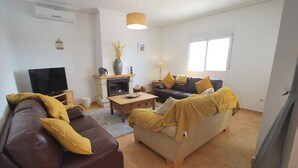 A living room with a fireplace, a sofa, a coffee table, and a television. - Finca in quiet area with private pool (Catral Alicante)