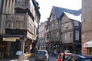 A narrow street with traditional half-timbered buildings, a café named 'CRÉPERIE', and parked cars. - Gite NEW COMFORT-classified 3 *** for 2/4Pers, quiet. MER Prox. ANCV / WIFI (pluduno)