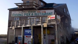 A two-story building with a sign that reads "Seaview Fishing Pier & Restaurant".