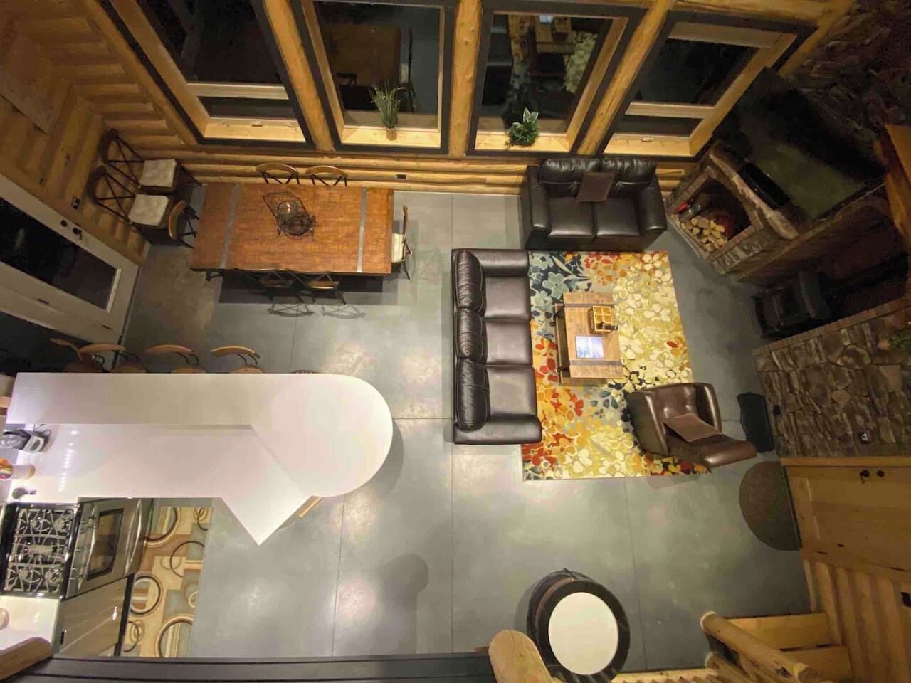 A spacious living area with a fireplace, seating, and a dining table.