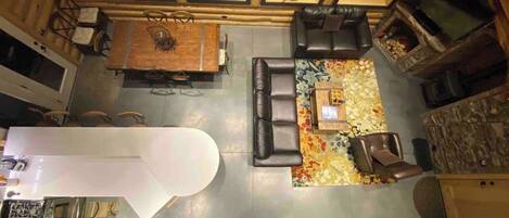 A spacious living area with a fireplace, seating, and a dining table.
