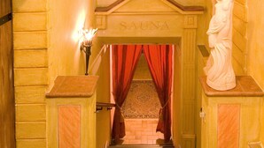 A grand staircase leading to a room labeled "SAUNA" with a statue on the right and a lamp on the left. - (21) Two-room vacation apartment 50 sqm, bathroom/WC, kitchen, balcony (Reit im Winkl)