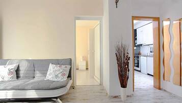 Family Apartment, 2 Bedrooms | Living area | 42-inch flat-screen TV with cable channels, TV, DVD player