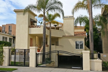 Exterior front with pedestrian gate and subterranean garage