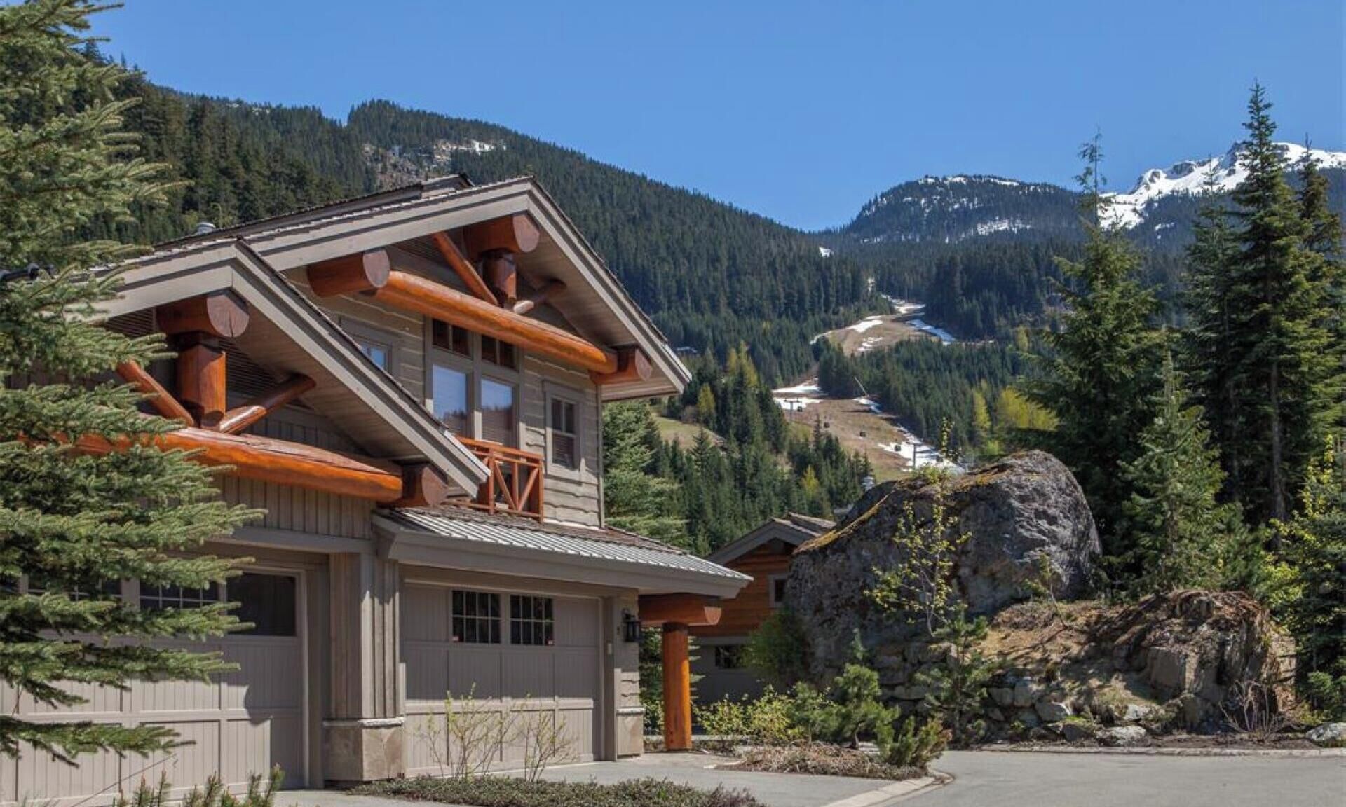 Exterior of our home in the Spring.  Peak to Creek ski run in background 

