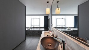 A modern bathroom with a large mirror, a wooden vanity, a copper basin, and pendant lighting. - Lucid Xixi Hotel (Hangzhou)