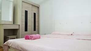 A bedroom with a bed, a nightstand, a wardrobe, and a mirror. - BekvämHome Impiria Residensi Klang (Klang)