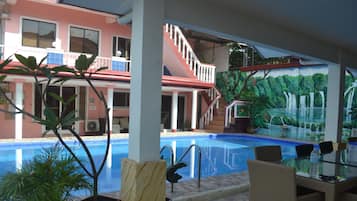Outdoor pool, open 6 AM to 10 PM, pool loungers