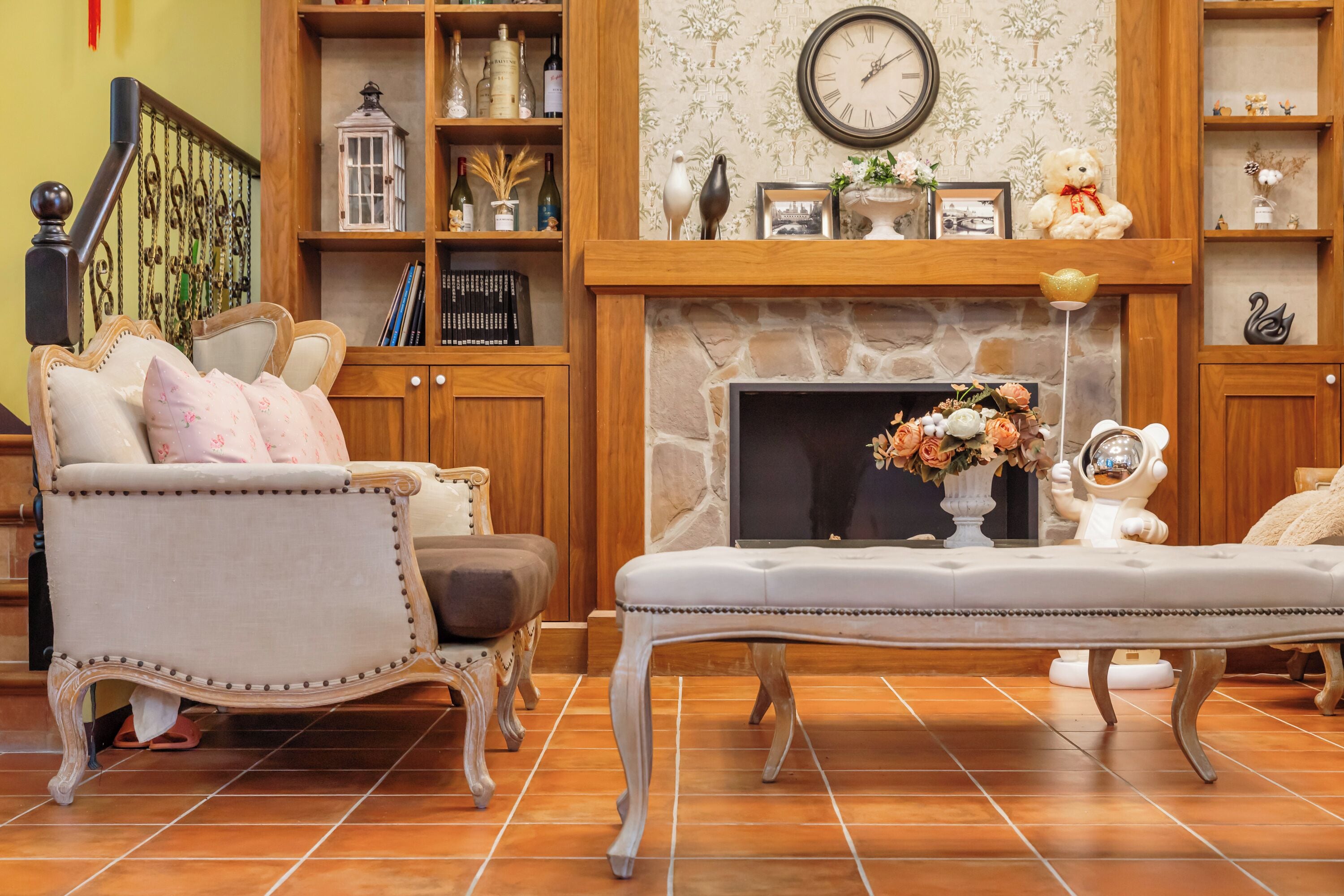 A living room with a fireplace, a sofa, a coffee table, and a bookshelf.