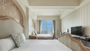 A hotel room with two beds, a television, and a large window. - Southern France (Checheng)
