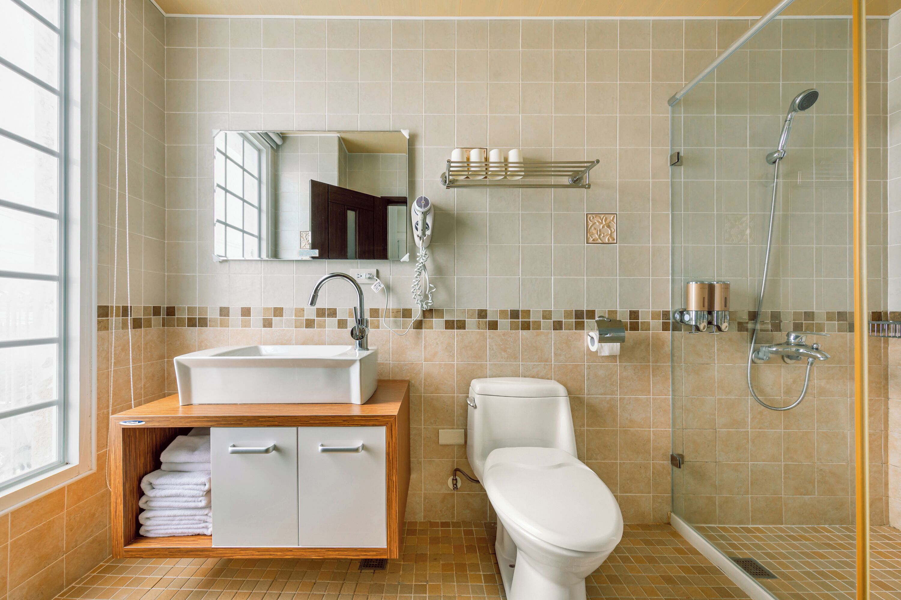 A bathroom with a sink, toilet, and shower.
