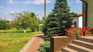 A pathway leading to a building with a brick entrance and steps.