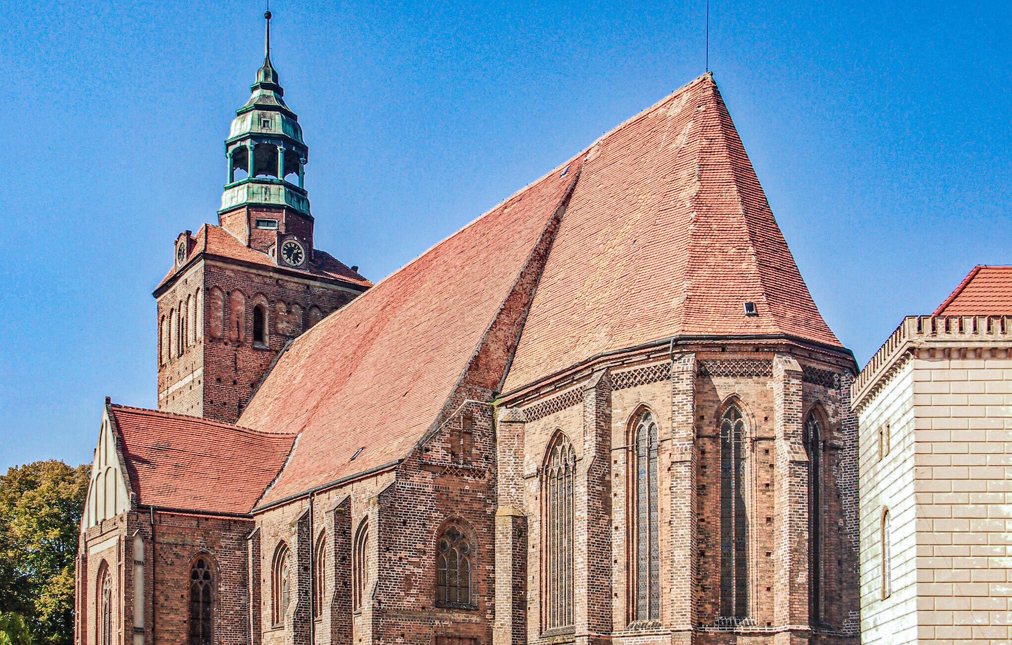 A historic church with a prominent steeple and a large, pointed roof.