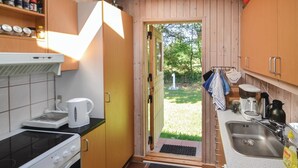 A compact kitchen with a stove, kettle, and sink. - Beautiful home in ørsted with kitchen (Ørsted)