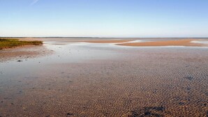 A wide, flat beach with clear water and distant dunes. - Beautiful home in ørsted with kitchen (Ørsted)