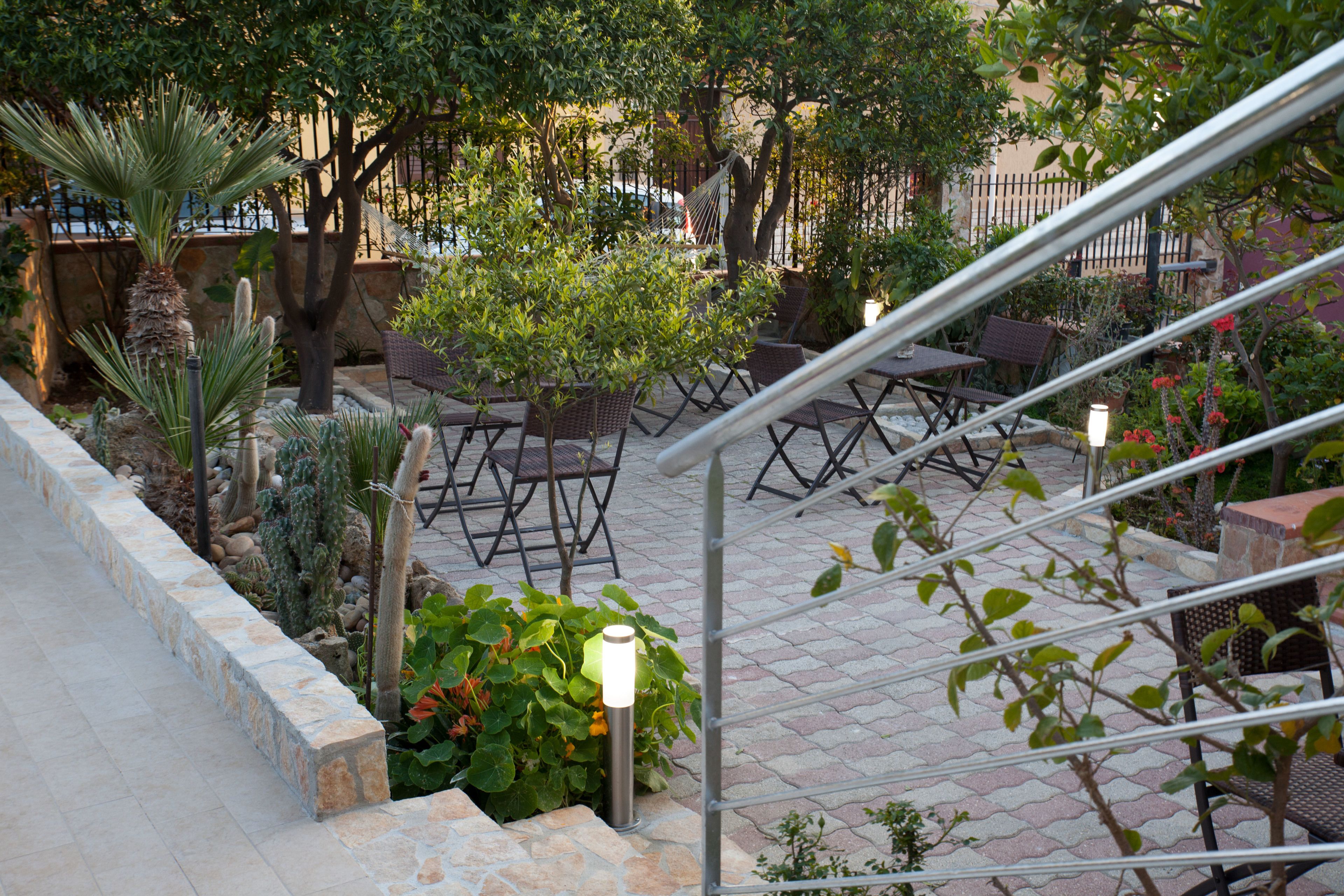 A patio area with outdoor seating, a hammock, and a staircase leading up.