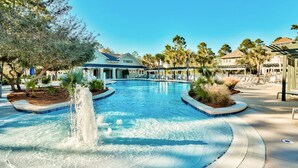 A swimming pool with a fountain, surrounded by palm trees and lounge chairs. - ☀️WaterSound 30A- Walk 2 Beach-Bikes-Pool-Anchors Up (Santa Rosa Beach)