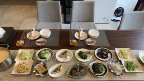A dining table set with various dishes and utensils, surrounded by grey chairs. - shanyue22 (Jiaoxi)