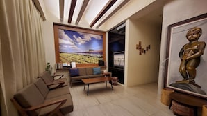A modern living room with a sofa, coffee table, and a painting of a landscape. - shanyue22 (Jiaoxi)