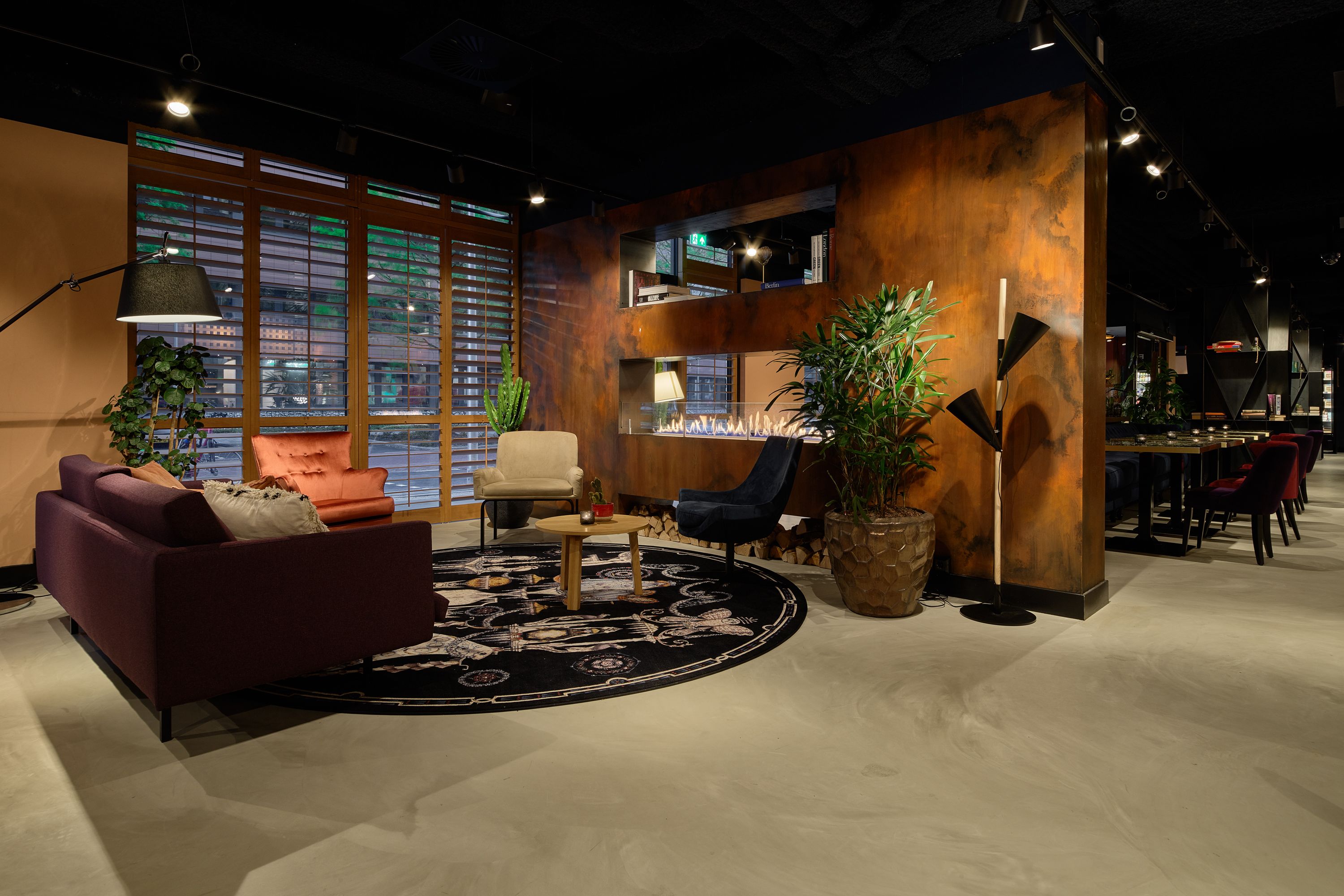 A modern interior with a sofa, armchairs, a coffee table, and a fireplace.