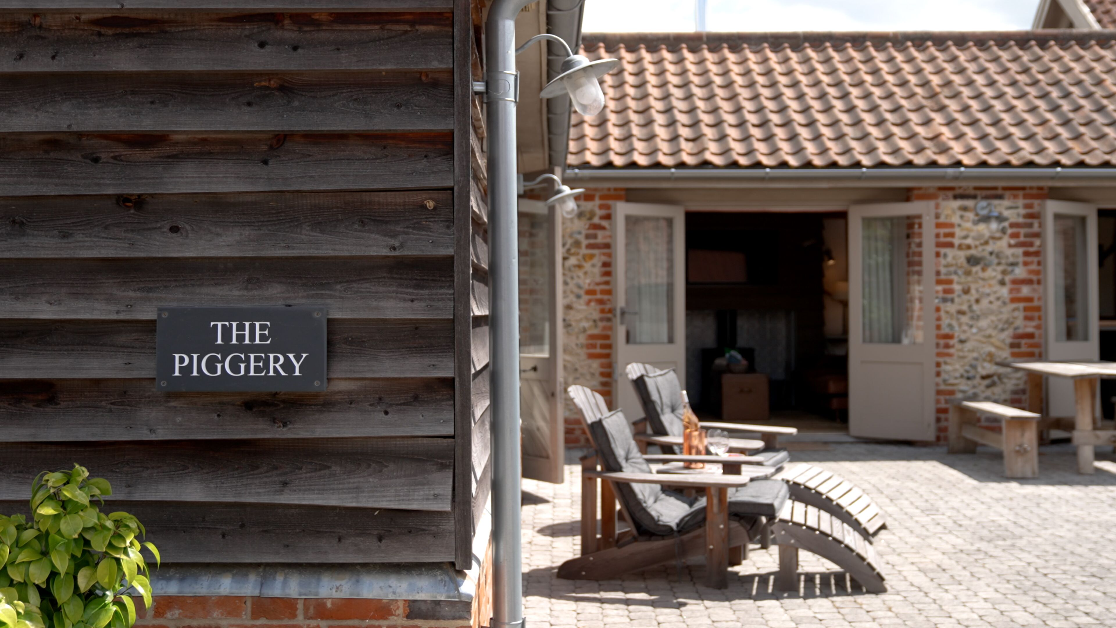 A wooden building with a sign reading "THE PIGGERY".