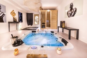 A modern spa room with a large hot tub, a wooden cabinet, and a mirror. - QuattroCuori Boutique Hotel & Spa (Portopalo di Capo Passero)