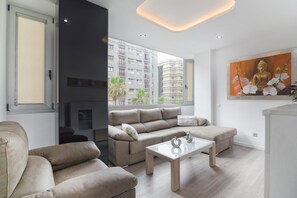 Een moderne woonkamer met een bank, een salontafel en een schilderij van een Boeddha.