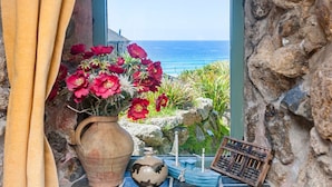 A rustic stone wall with a view of the ocean. - Whitebreakers, Beach Cottage, Sea-views, Garden (Sennen)