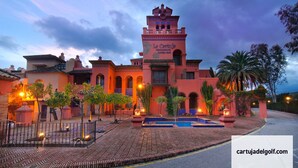 A traditional Spanish-style building with a tower, a swimming pool, and a well-maintained courtyard with trees and a fountain. - LUXURY MARBELLA DUPLEX OF 3 CH - 3 SDB - OF 155 M² + TERRACES 100 M²  (estepona)