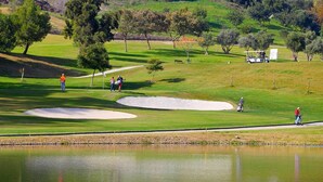 A golf course with sand bunkers, a pond, and a walking path. - LUXURY MARBELLA DUPLEX OF 3 CH - 3 SDB - OF 155 M² + TERRACES 100 M²  (estepona)