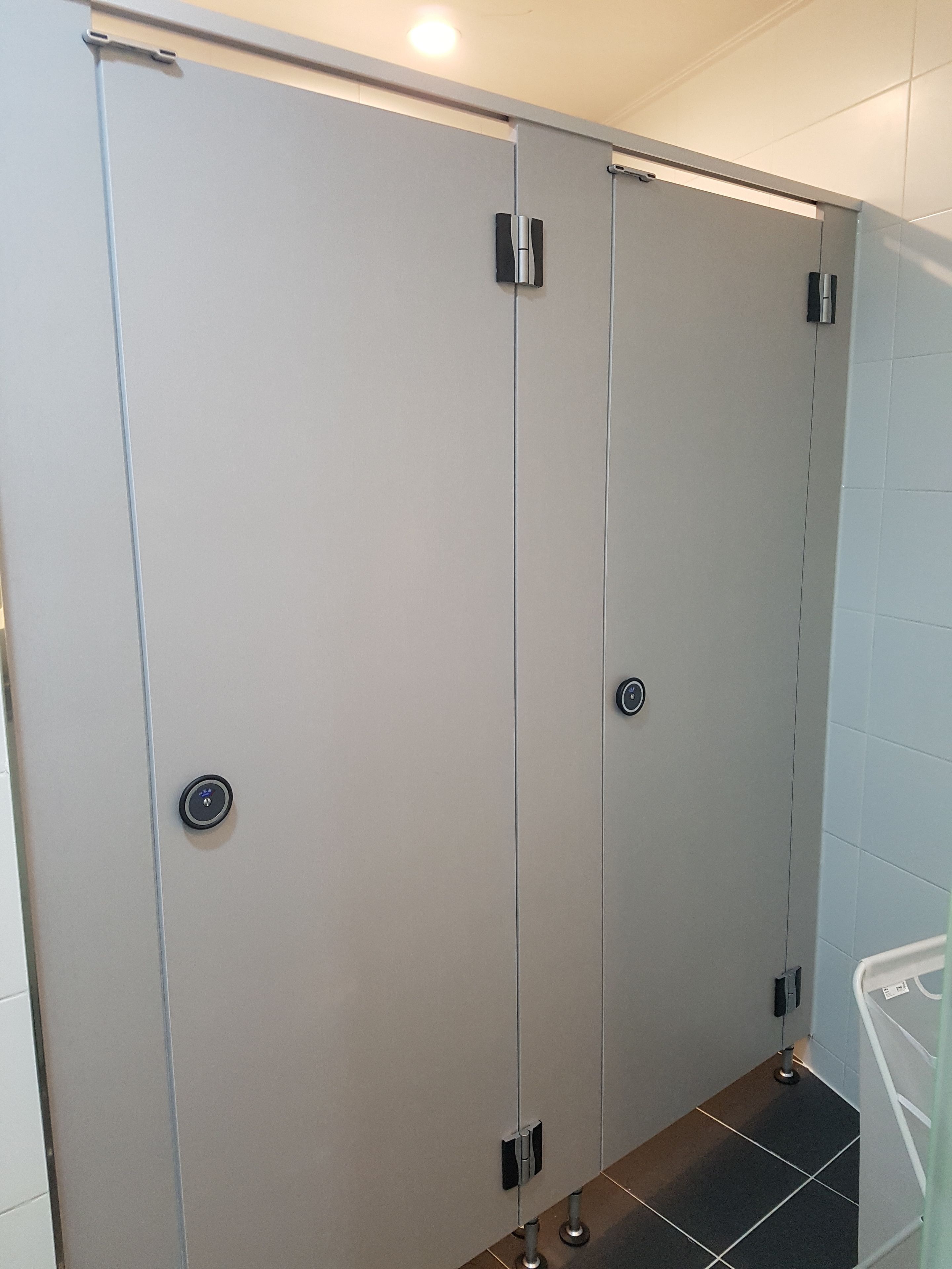 A bathroom with a large mirror, a toilet, and a sink.