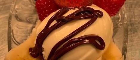 A dessert with strawberries and banana slices on a glass plate.