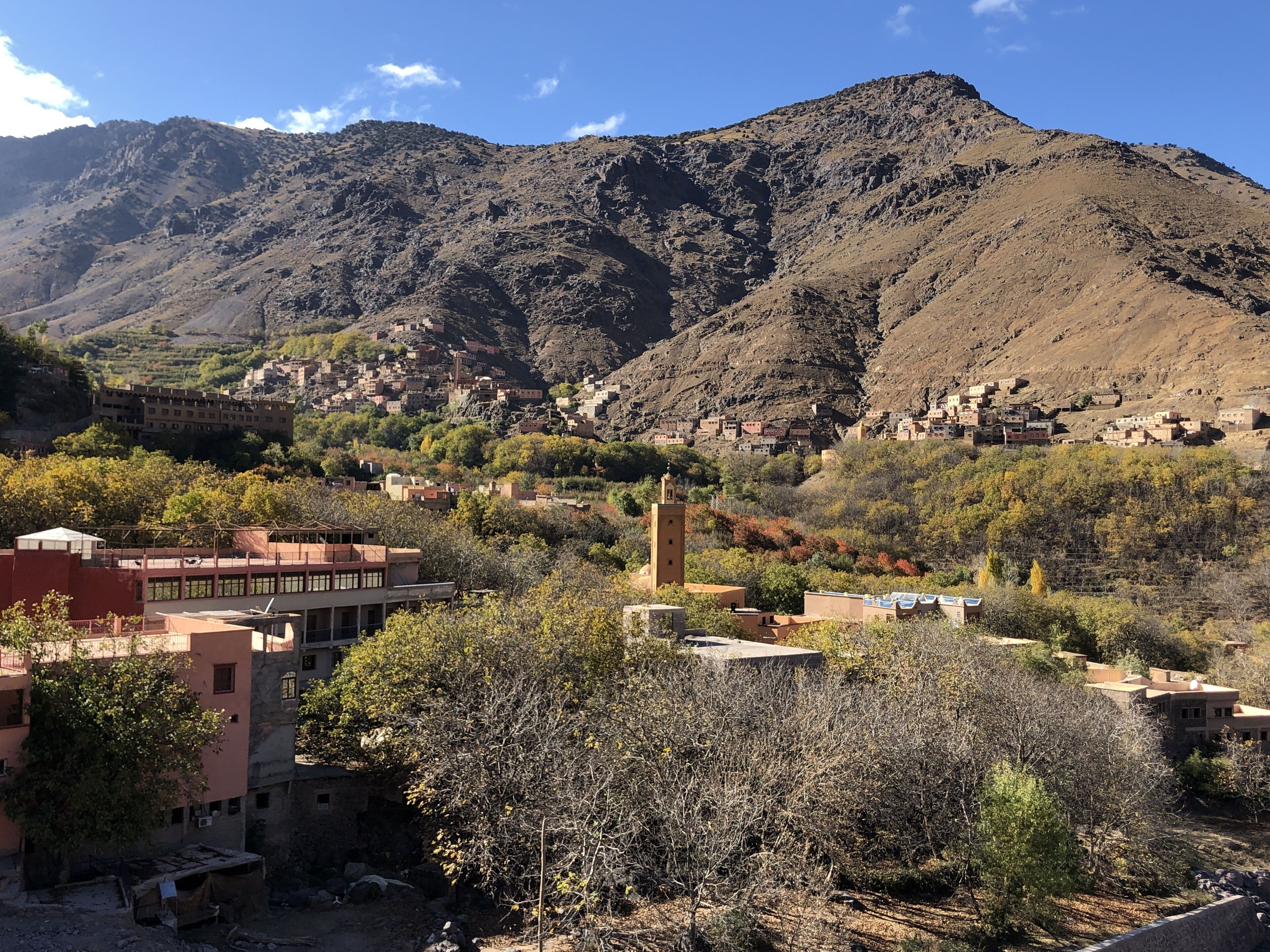 A mountainous landscape with a village nestled in the valley.