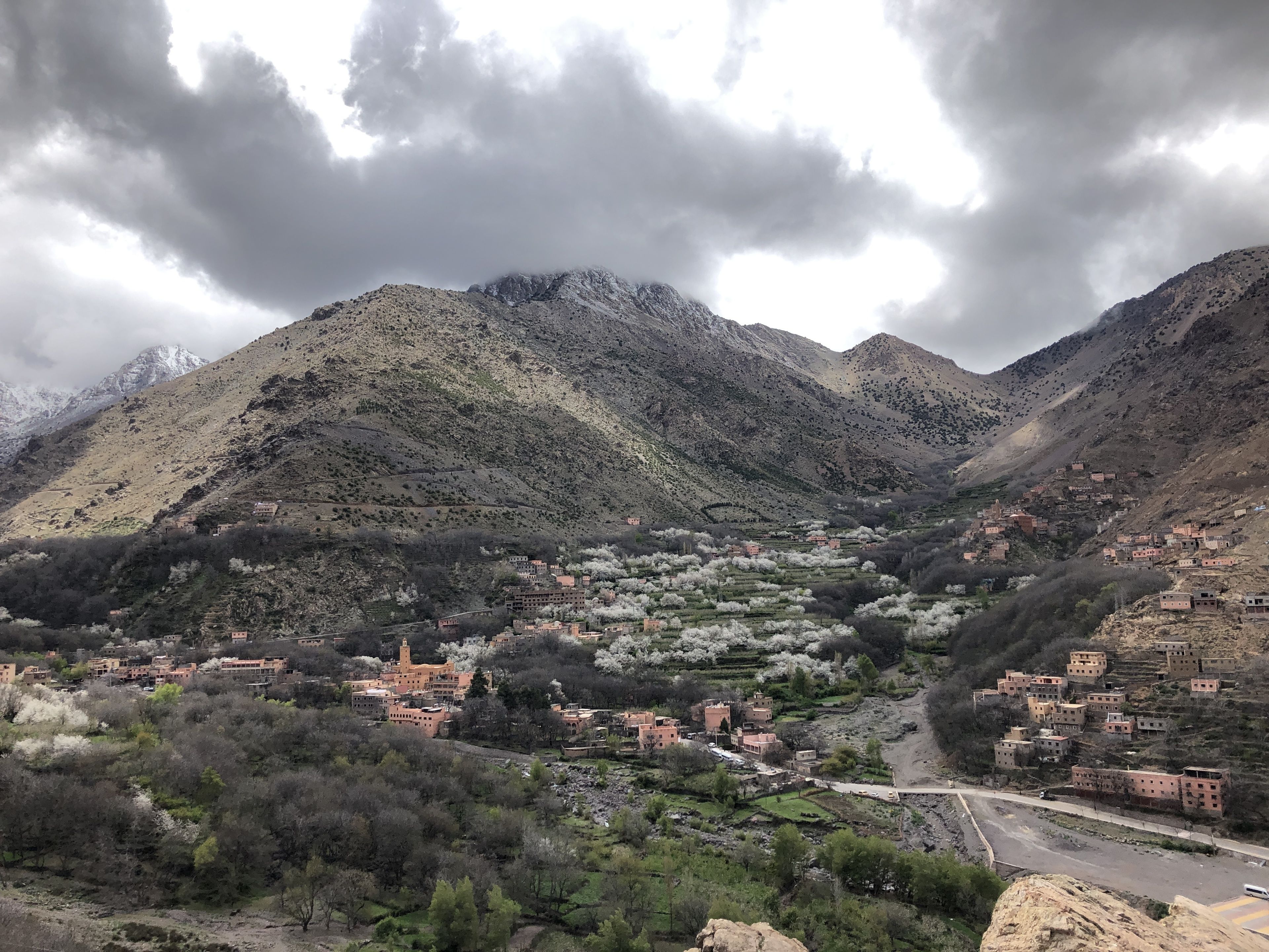 A mountainous landscape with terraced houses and a winding road.