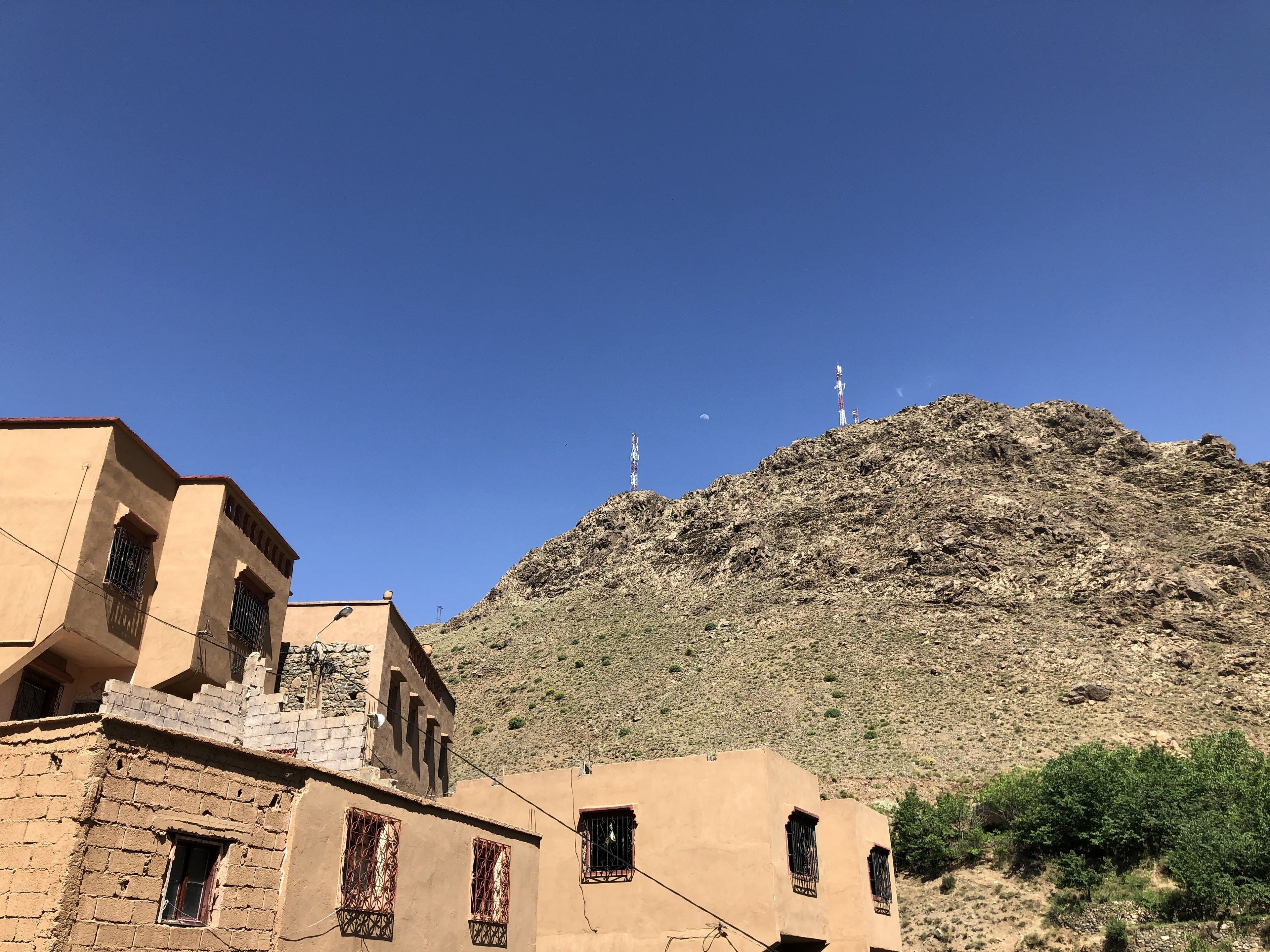 A mountainous landscape with buildings in the foreground.