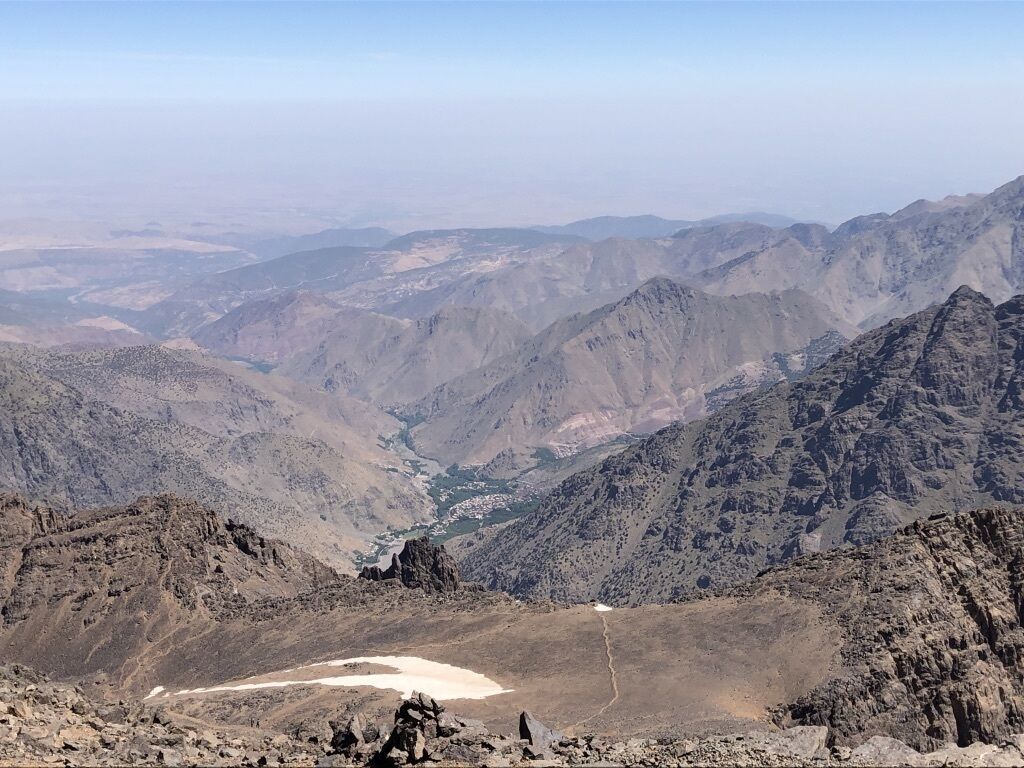 A mountainous landscape with rugged terrain and a visible valley.