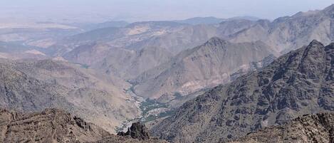 A mountainous landscape with rugged terrain and a visible valley.