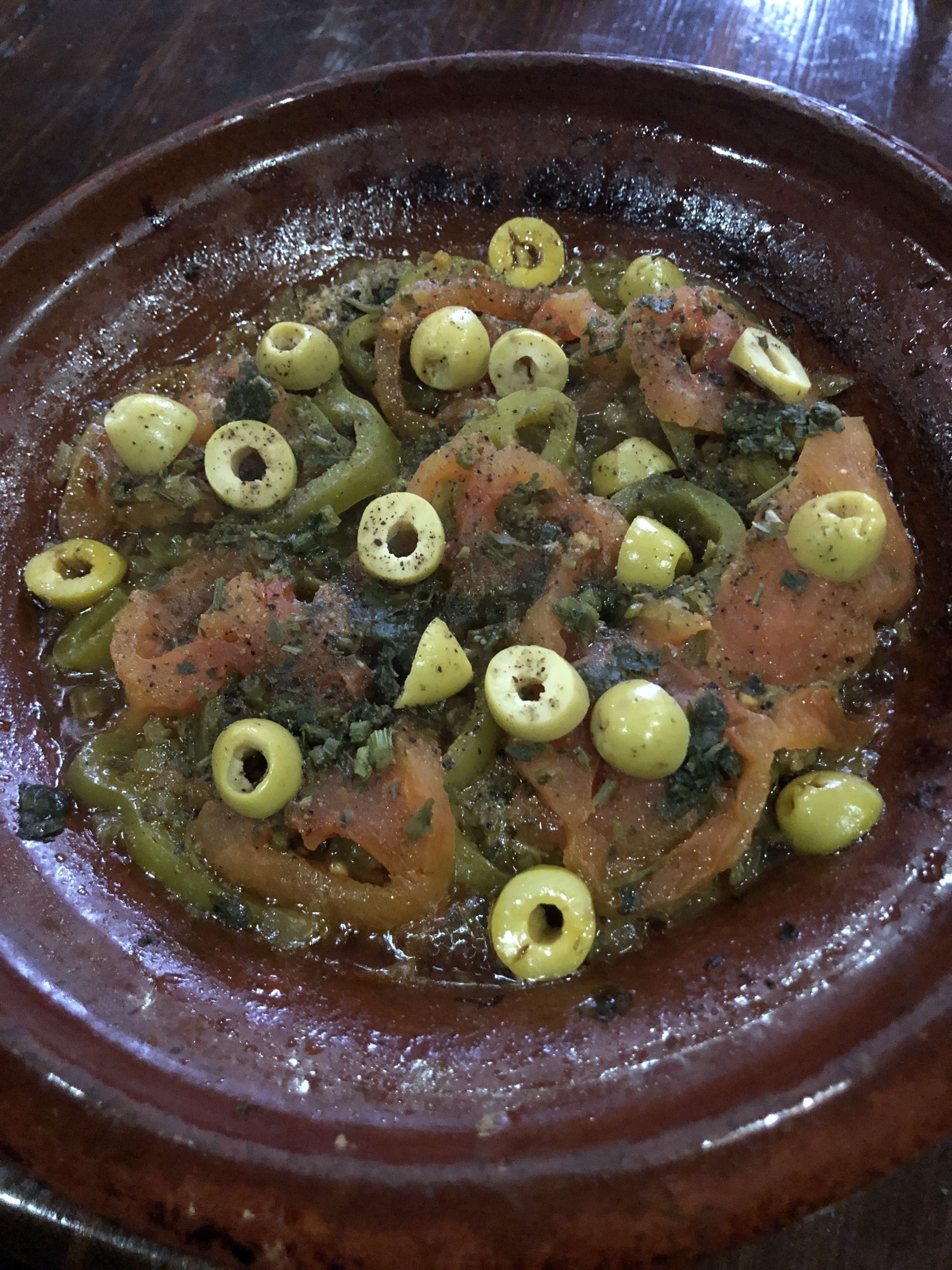 A traditional Moroccan tagine dish with olives and vegetables.