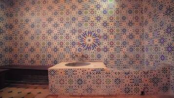 Bathroom features a unique tile pattern and a modern sink with a simple faucet.