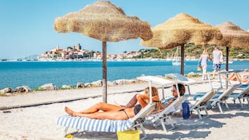 On the beach, sun loungers, beach umbrellas