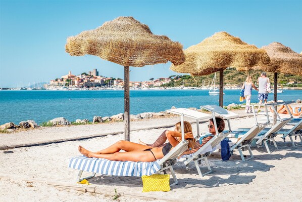 On the beach, sun-loungers, beach umbrellas