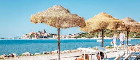 On the beach, sun loungers, beach umbrellas