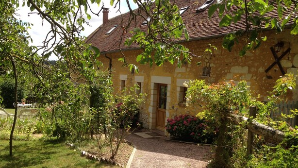 A stone building with a tiled roof, a gravel path leading to the entrance, and surrounding greenery. - Domaine de la Haute Poignandière (Saint-Germain-de-la-Coudre)