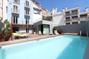 Outdoor pool, open 9:00 AM to 8:00 PM, pool umbrellas, pool loungers
